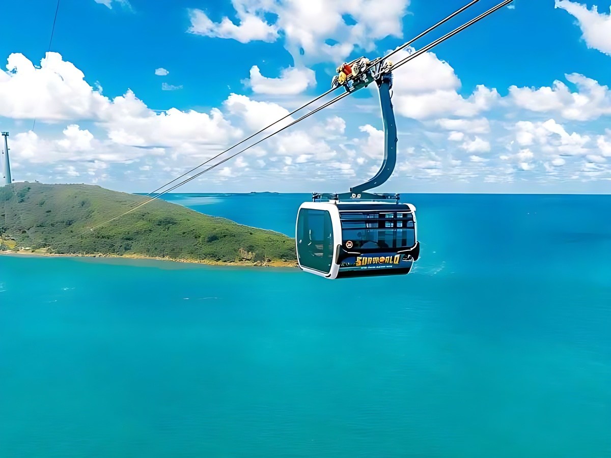 Travelers enjoying views of the sea and islands from the modern three-cable system.