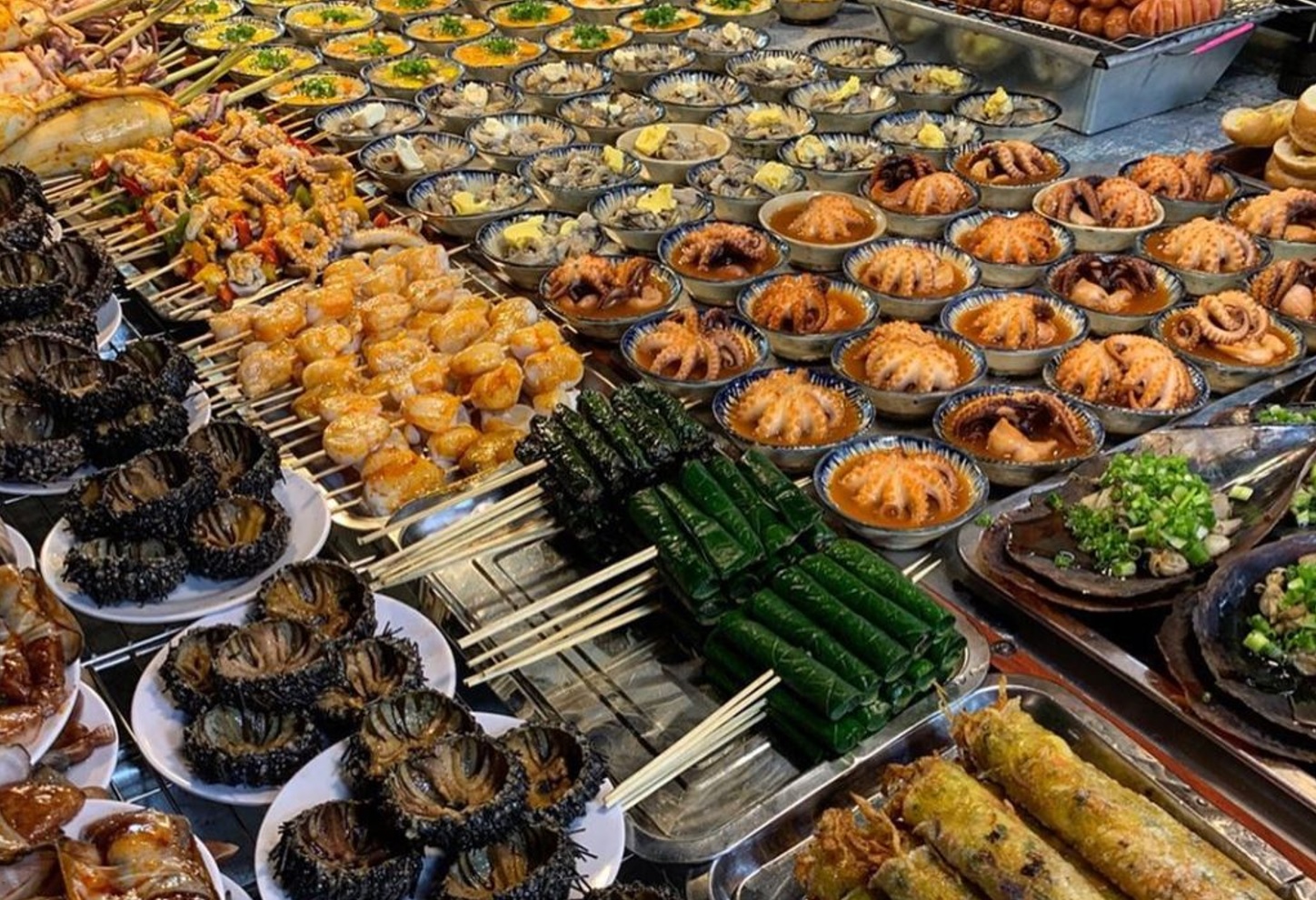 Diverse ready-to-cook seafood dishes and skewers